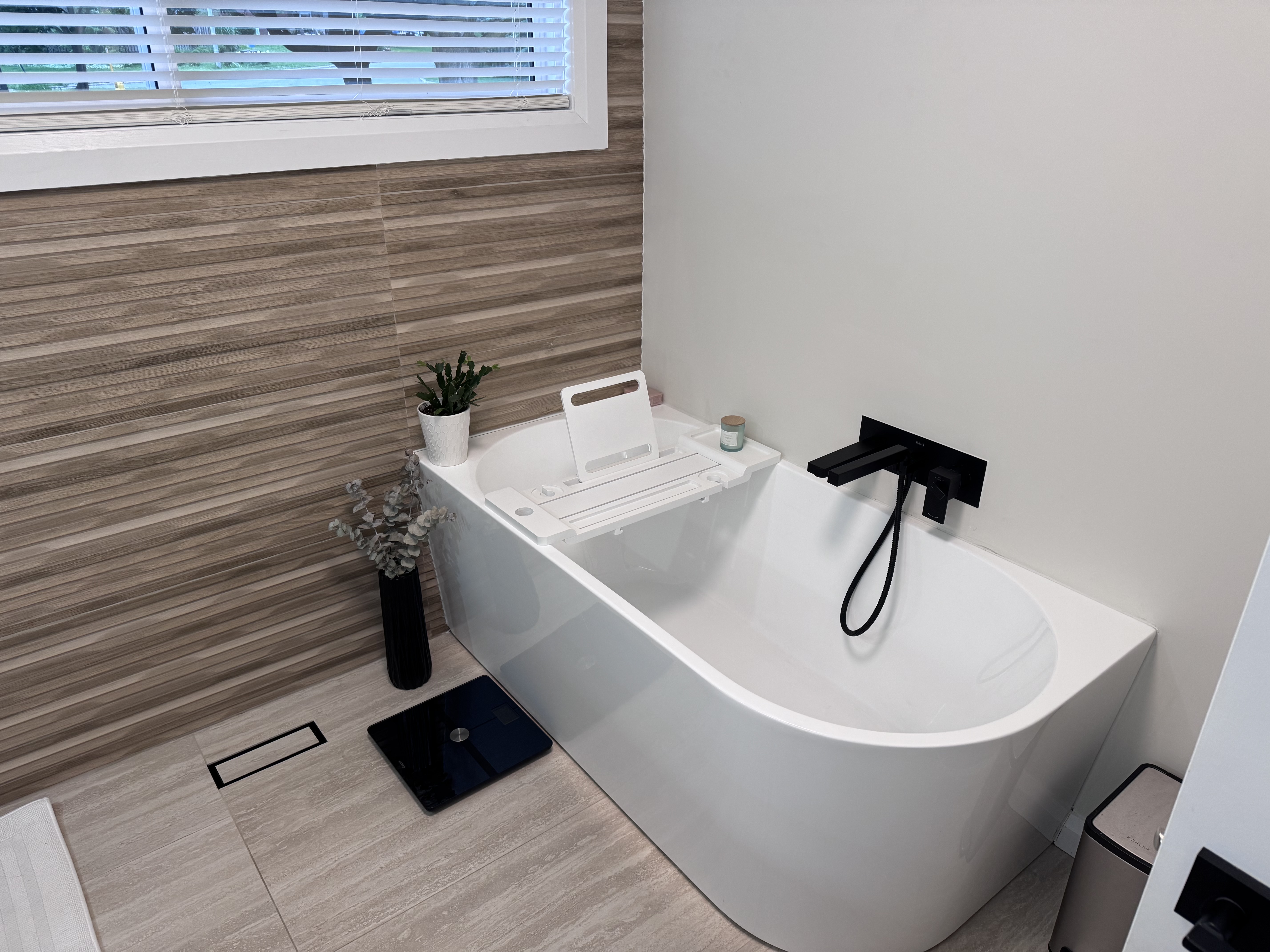 Freestanding soaker tub with matte black fixtures