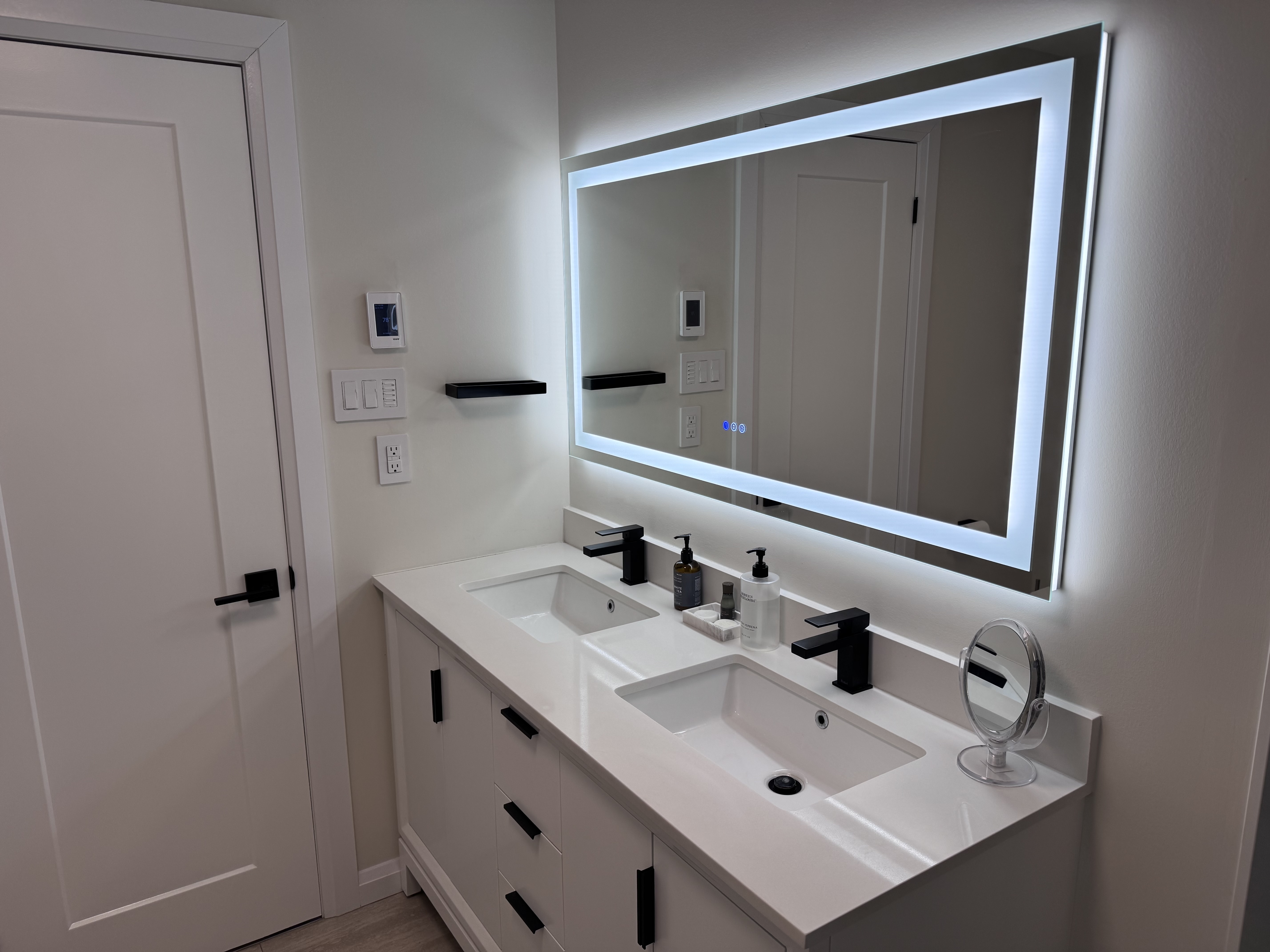 Double vanity with LED backlit mirror