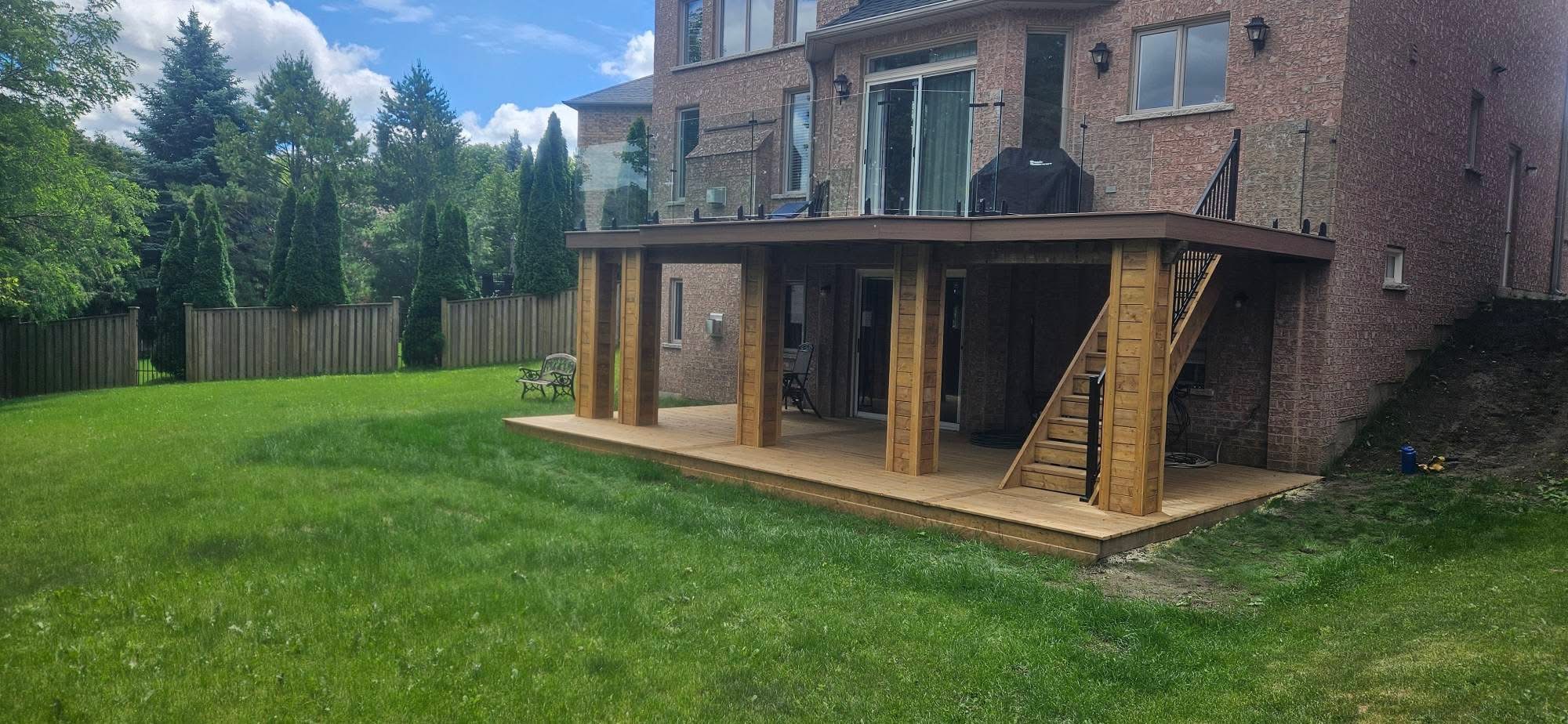 Custom two-level deck with glass railings